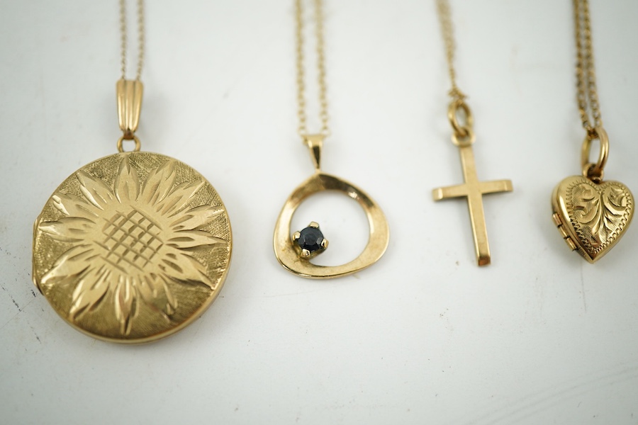 A collection of jewels, comprising: two cross pendants; a heart-shaped locket pendant; a circular locket pendant engraved with a sunflower; a pendant set with a sapphire; a diamond panel brooch; and a sapphire and diamon